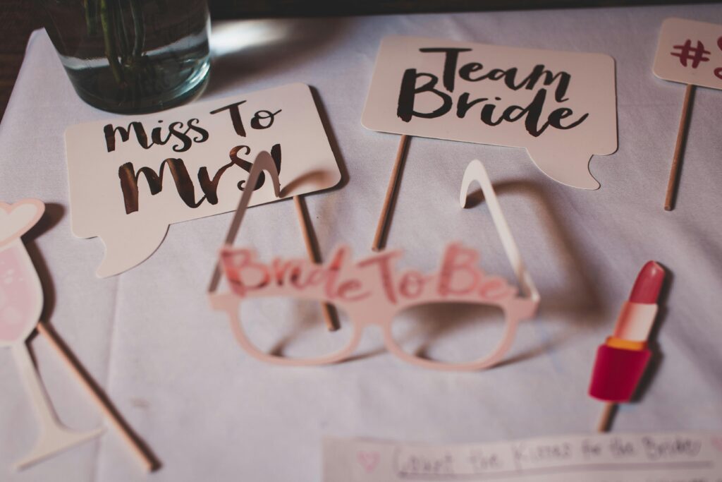 pexels-photo-2449445-2449445 Flat lay of bridal shower decorations with creative signs and props.